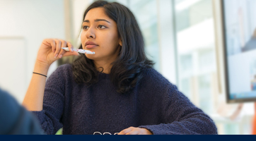 a young female student sitting in a classroom